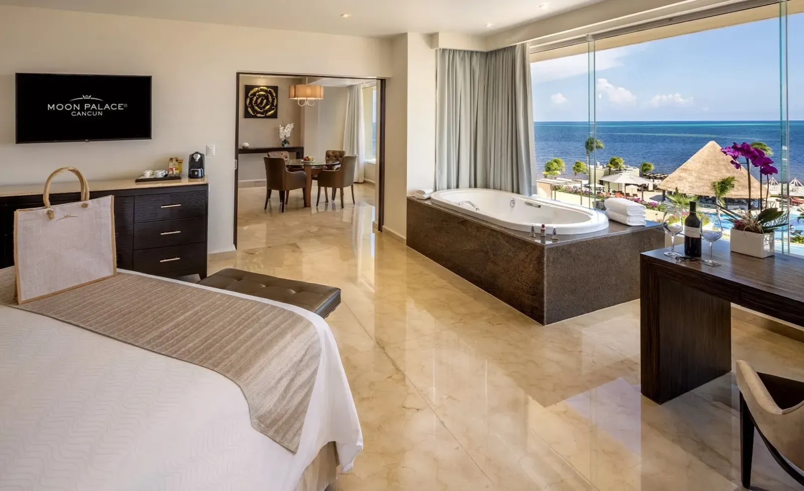 Bed, television cabinet and dining area in a Superior Governor Suite