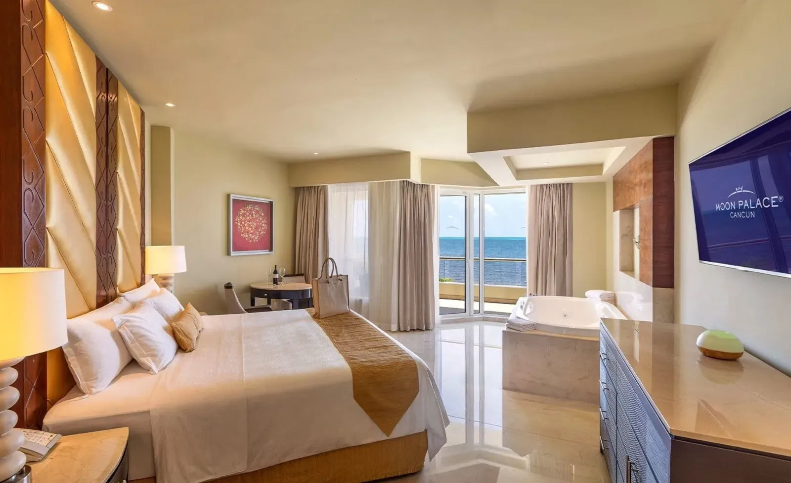 A bedroom in the Superior Two Bedroom Presidential Suite, with the sea beyond the window