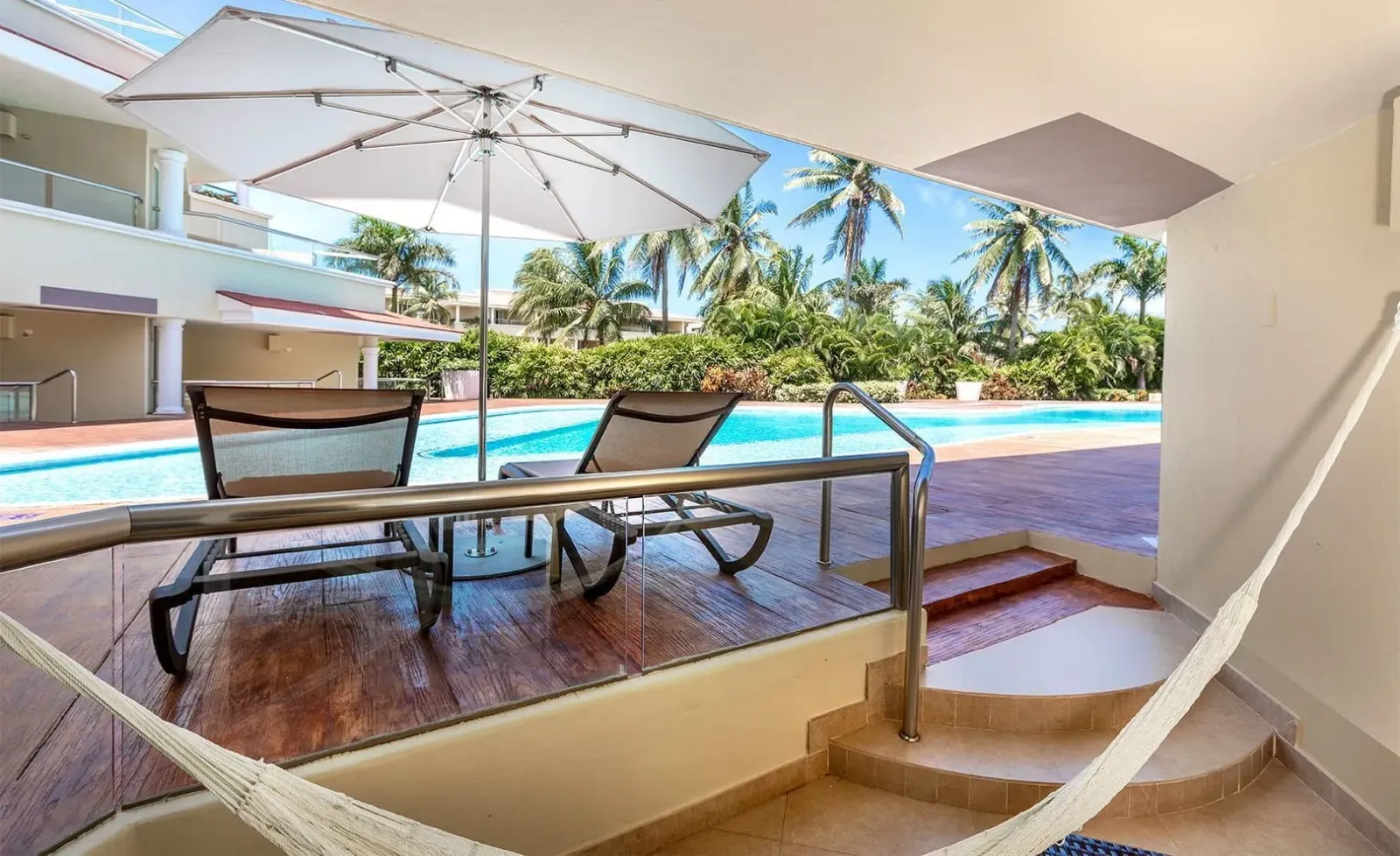 Patio with loungers and pool access at a Swim Up Suite