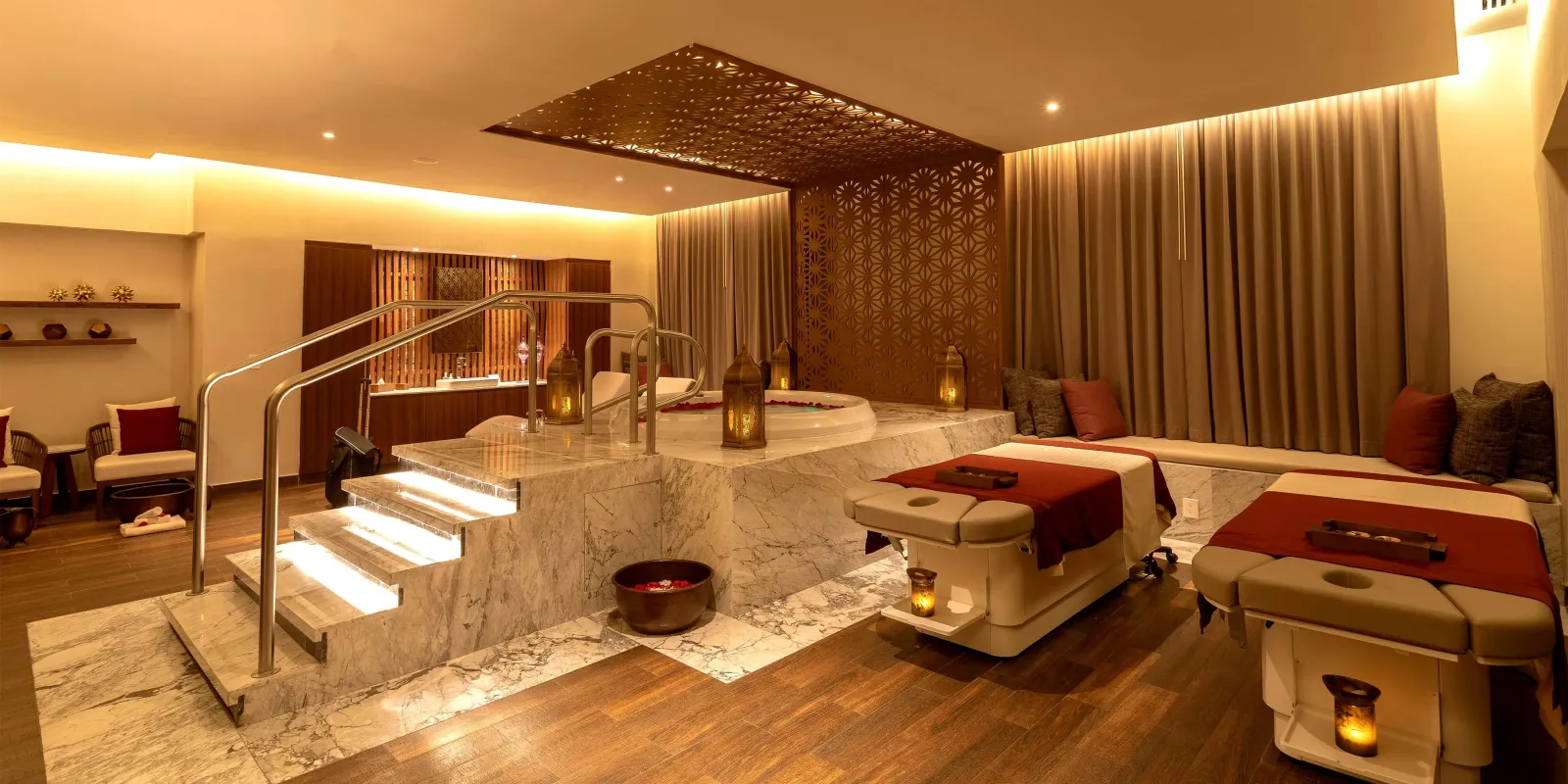 A bath, loungers and timber walls in a room at O Spa