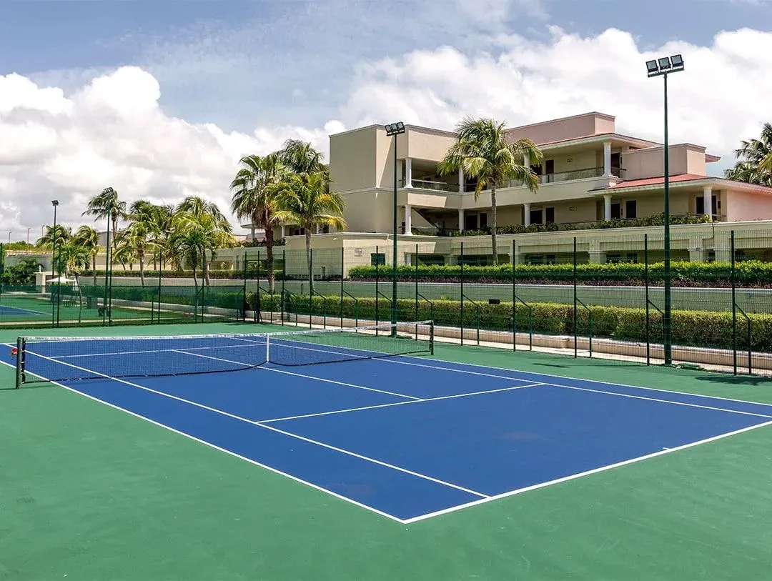 Sunrise’s tennis court with its net and palms beyond