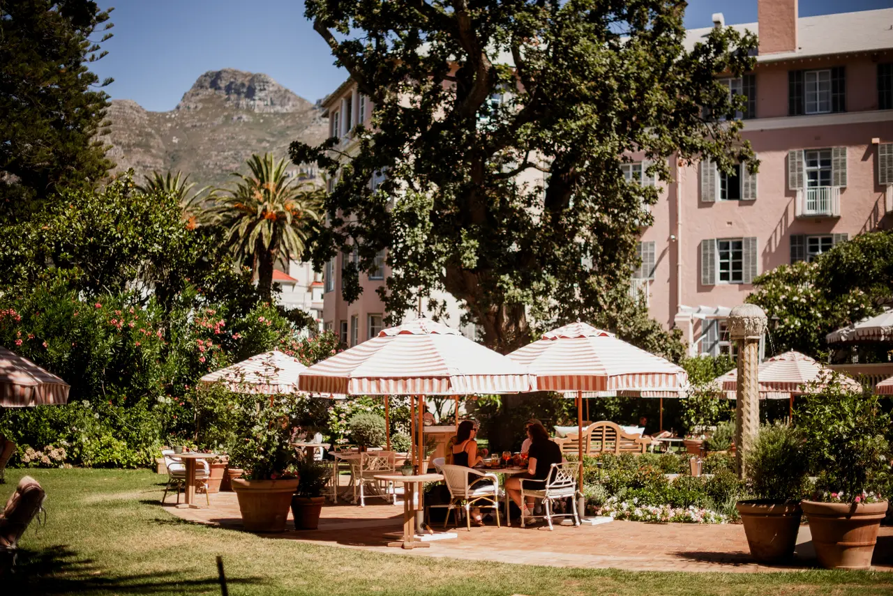 The Fountain terrace with coral-striped parasols and the mountain behind