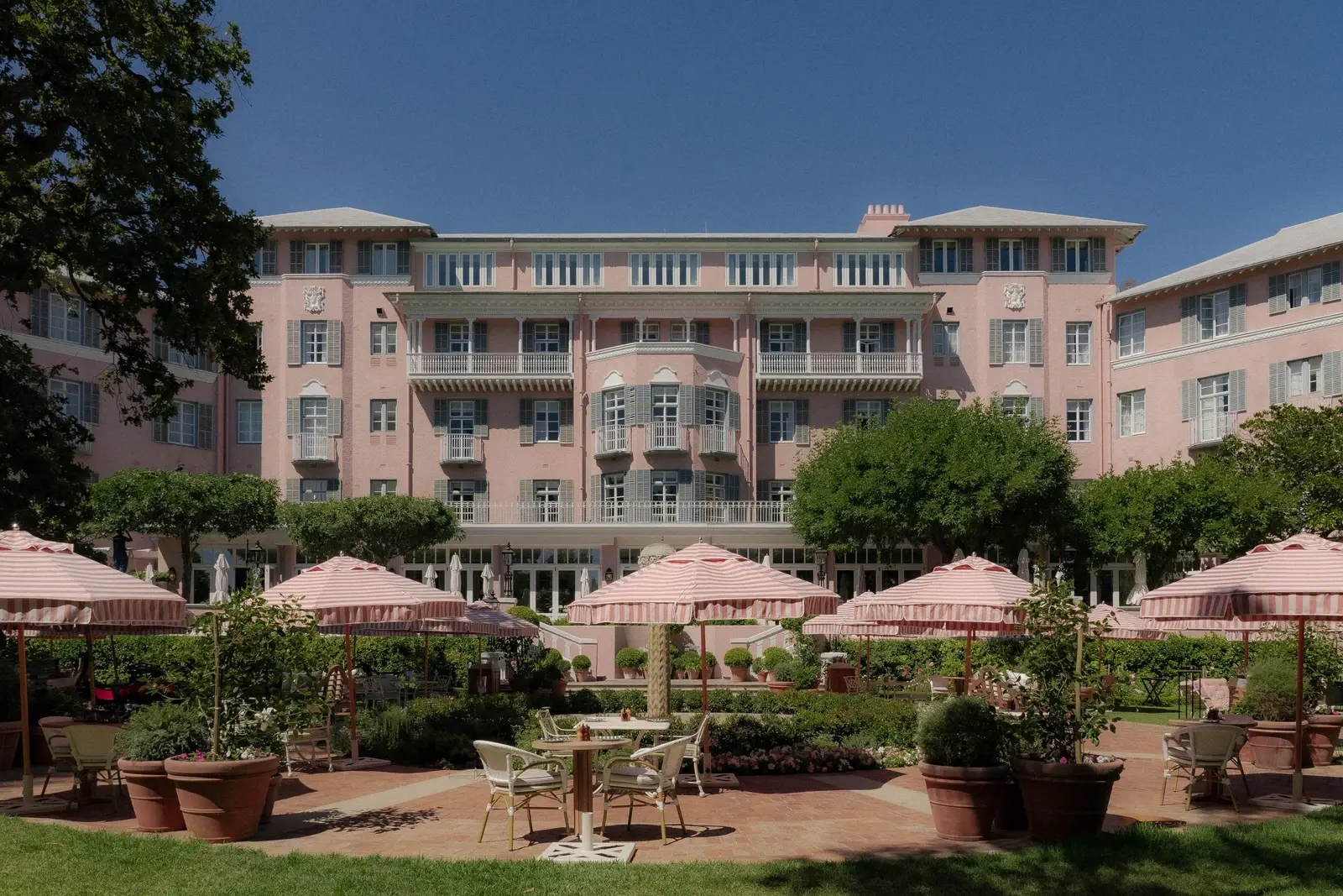 The garden fountain among rose beds, in afternoon sun