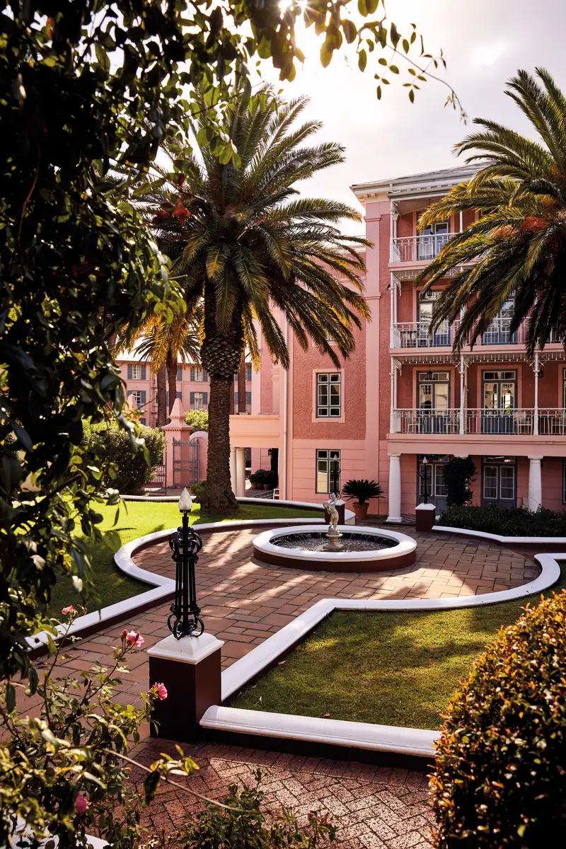 A courtyard fountain among the hotel’s pink wings