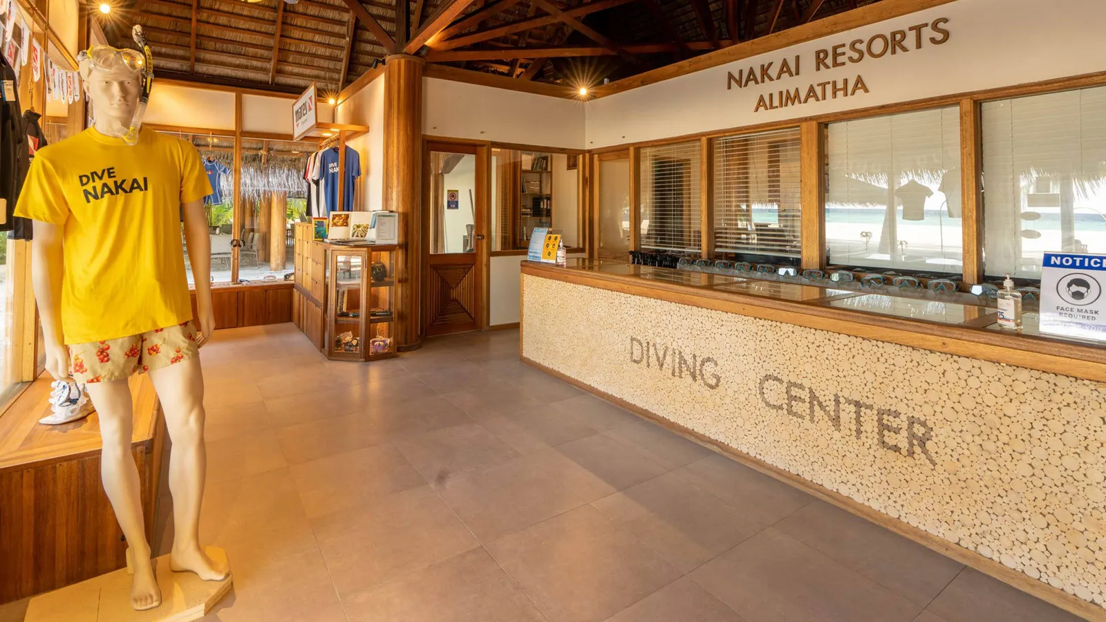 The counter of the NAKAI dive centre on Alimathà, with its display cases and dive T-shirts.