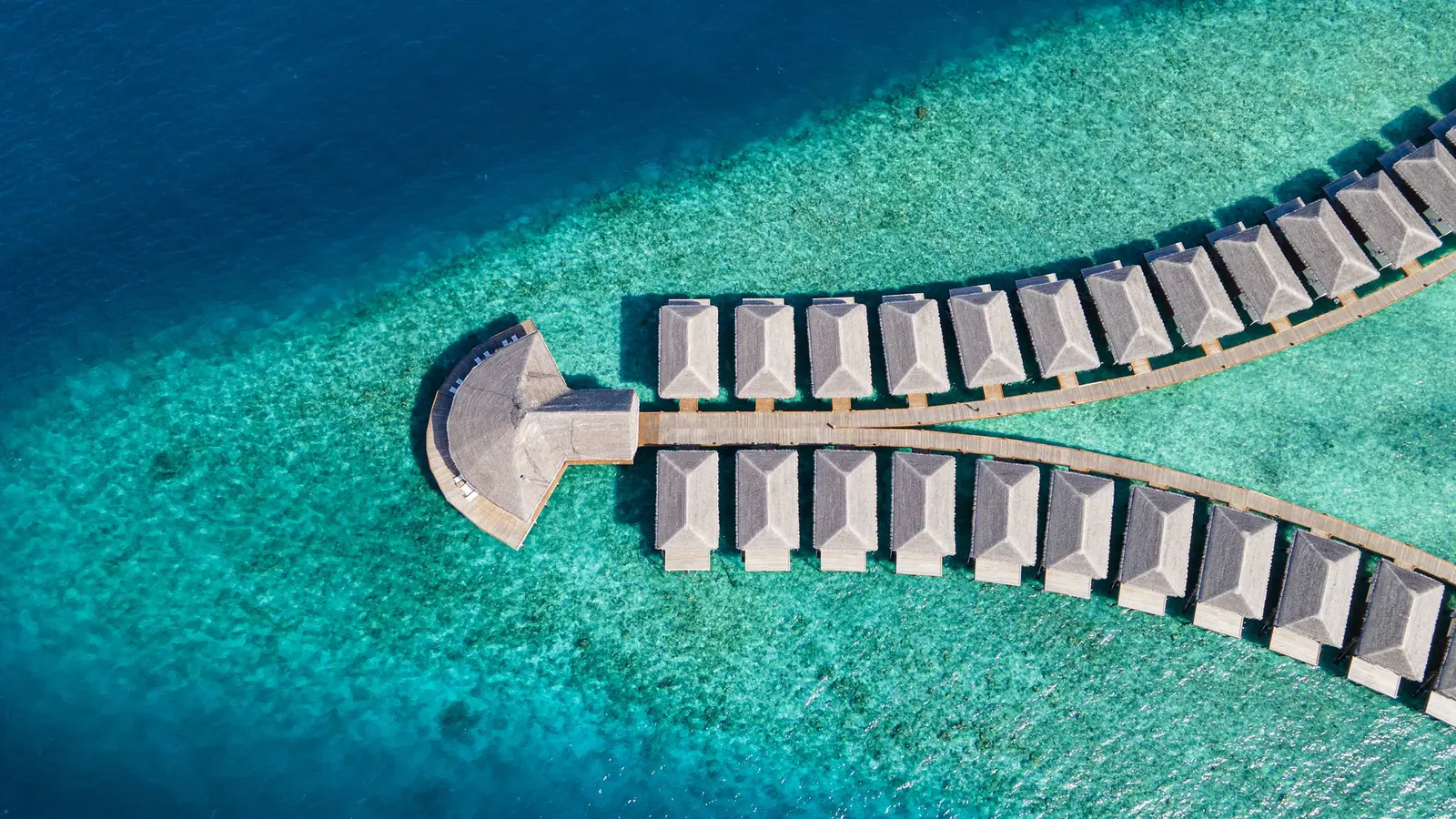 From above, the jetty’s 2 arms of water bungalows ending at the restaurant.