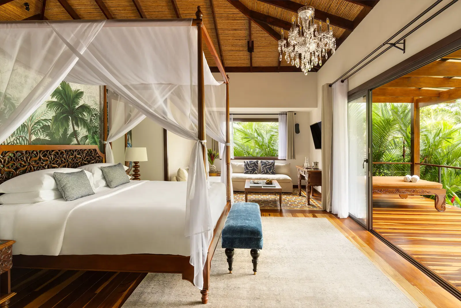 The Springs Villa’s four-poster bed and the terrace beyond the glass doors