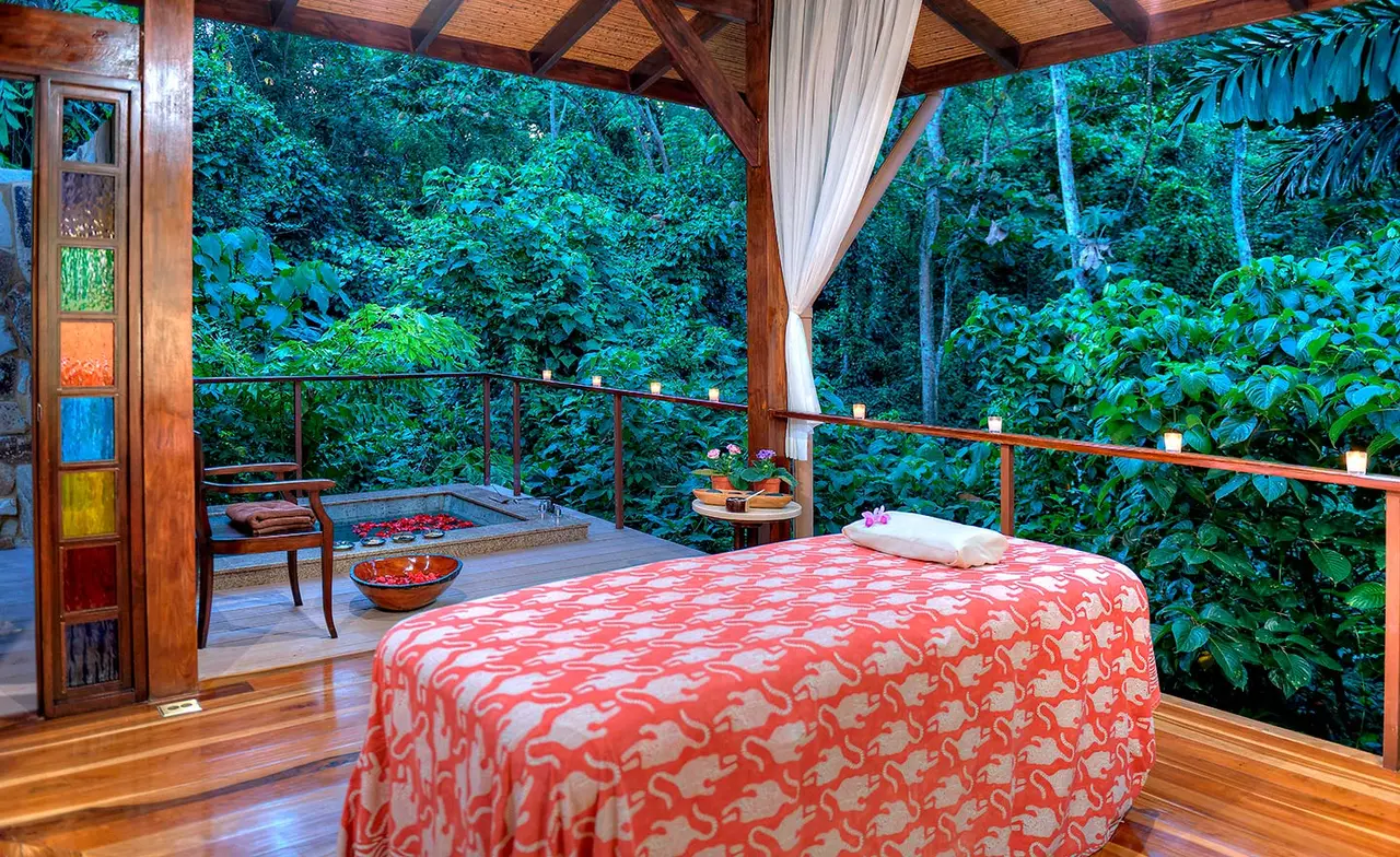 A massage bed in a pavilion open to the rainforest