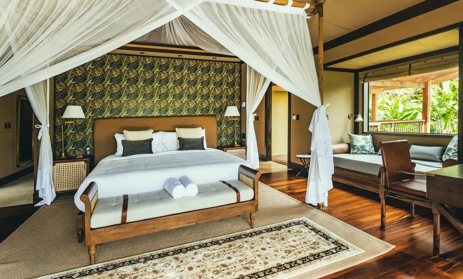 The Family Tent’s main bedroom, with a four-poster bed and sofa