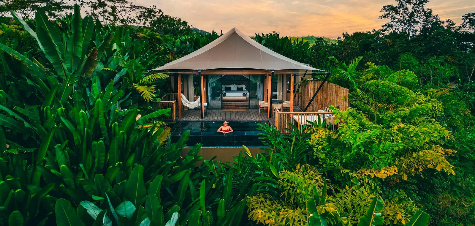 A tent with its private pool and terrace among the trees