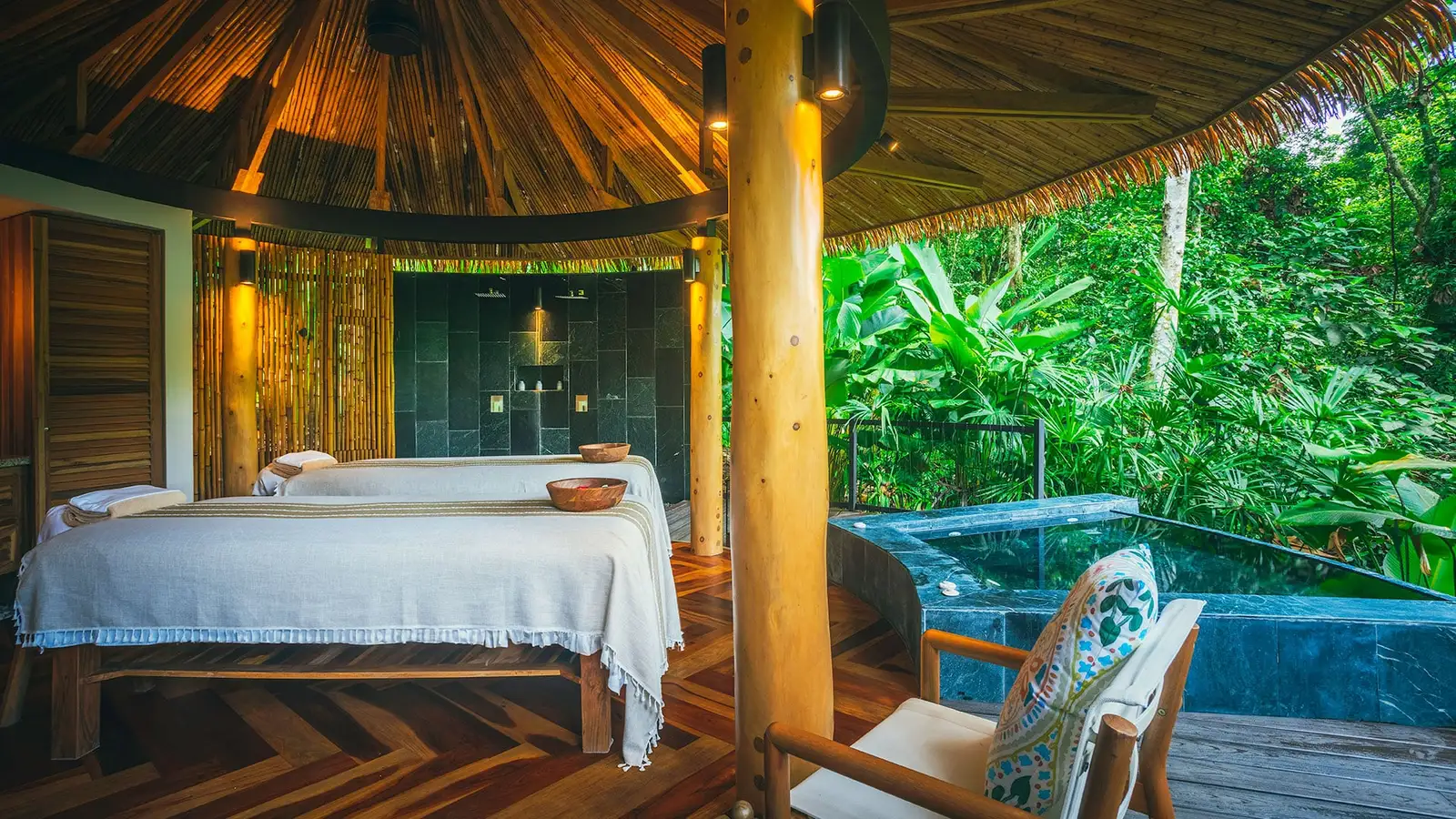 Massage beds in a pavilion open to the rainforest
