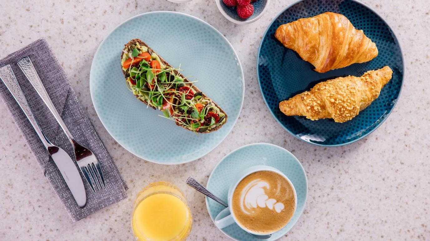 Pane, croissant, toast, caffè e succo per la colazione