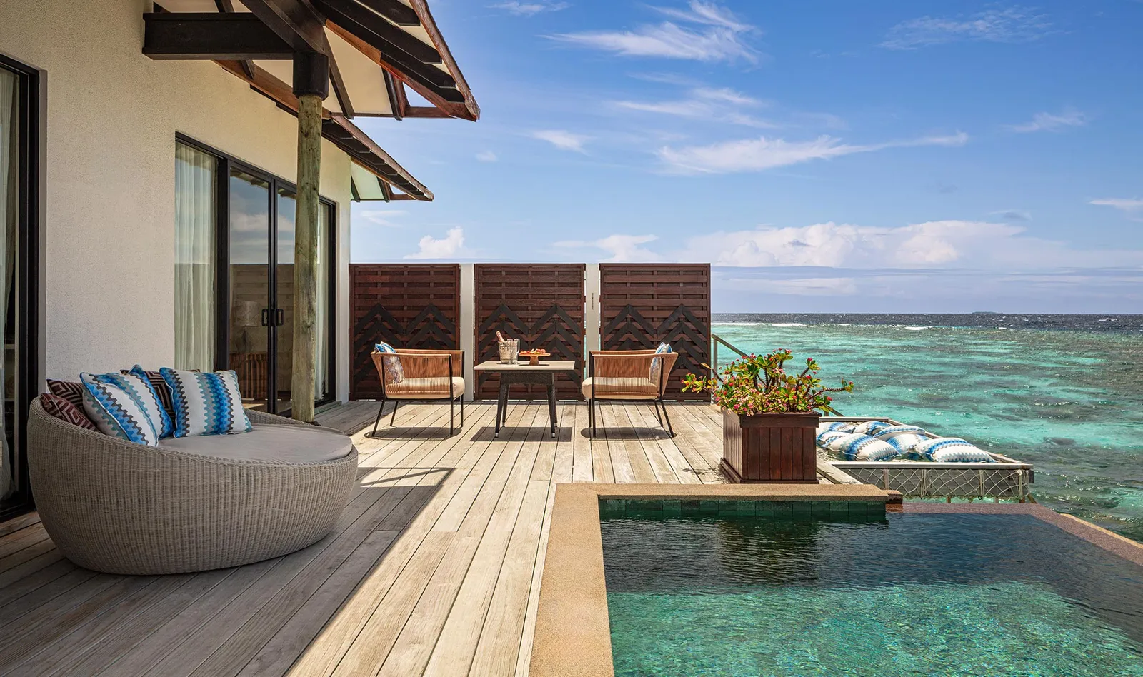 The water suite’s deck: the round daybed, the table and the plunge pool above the lagoon.