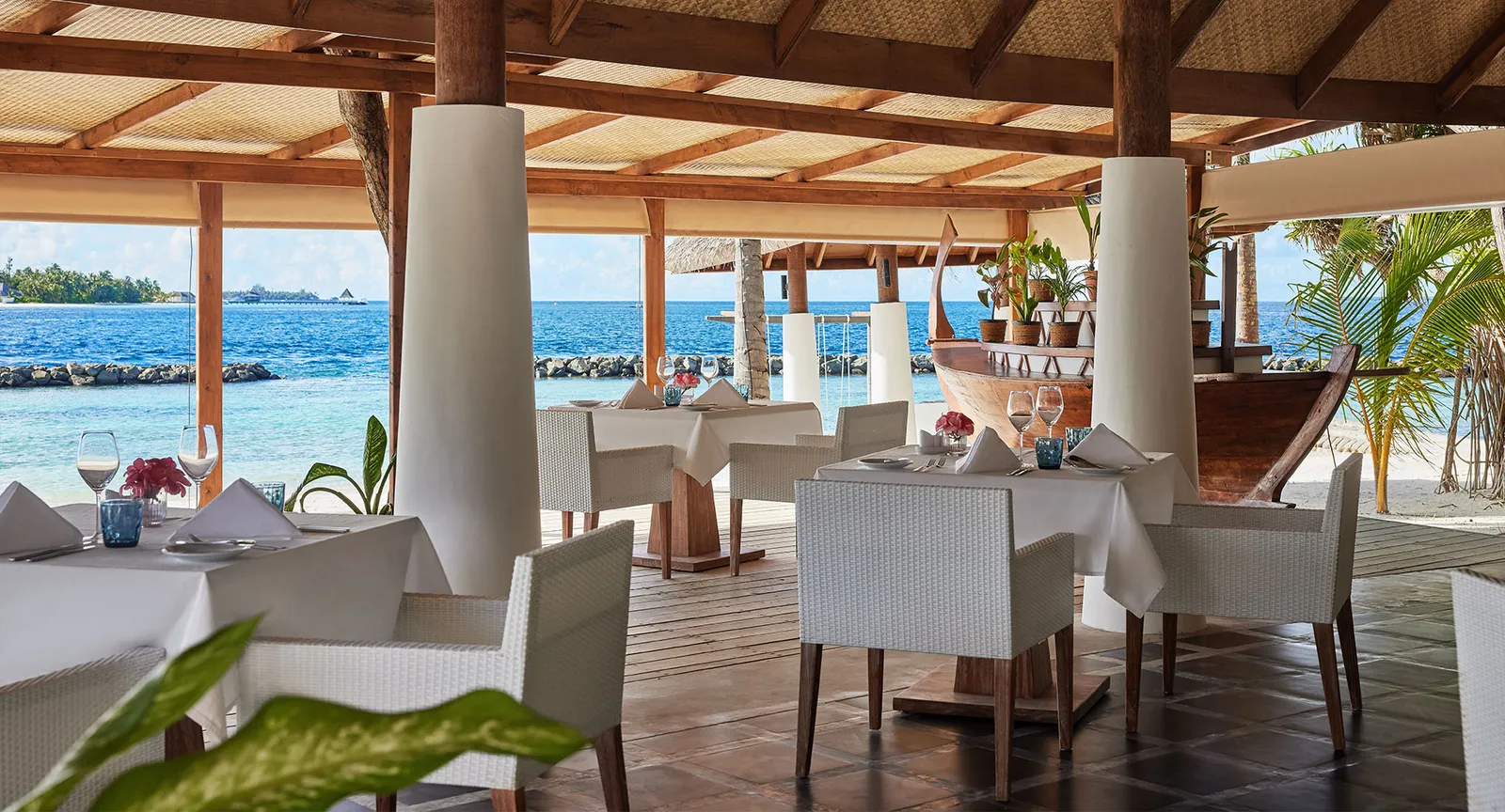 Ocean’s laid tables under the timber roof, open to the beach and the sea.