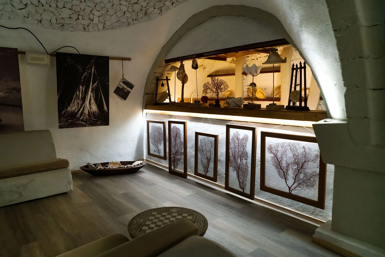 The underground museum: white coral vaults, lit display cases and black-and-white prints.