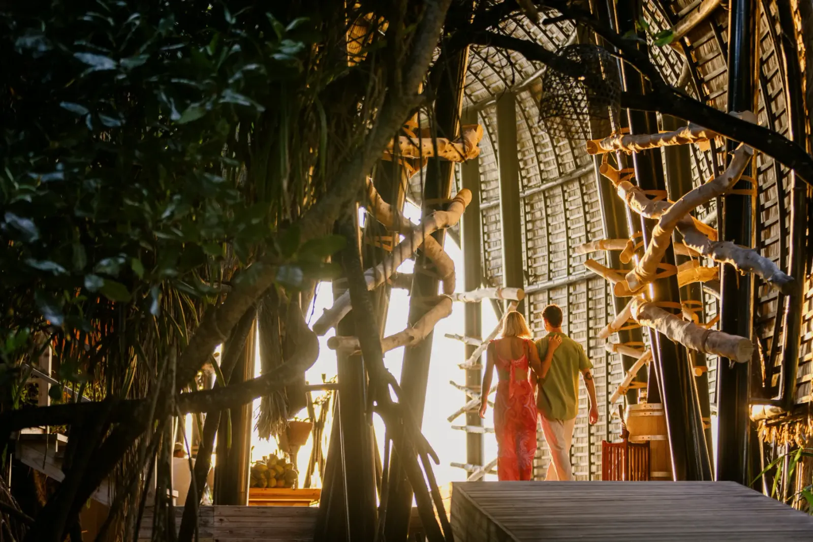 Haali Bar: the timber nest among the trees and a couple walking down to the beach.