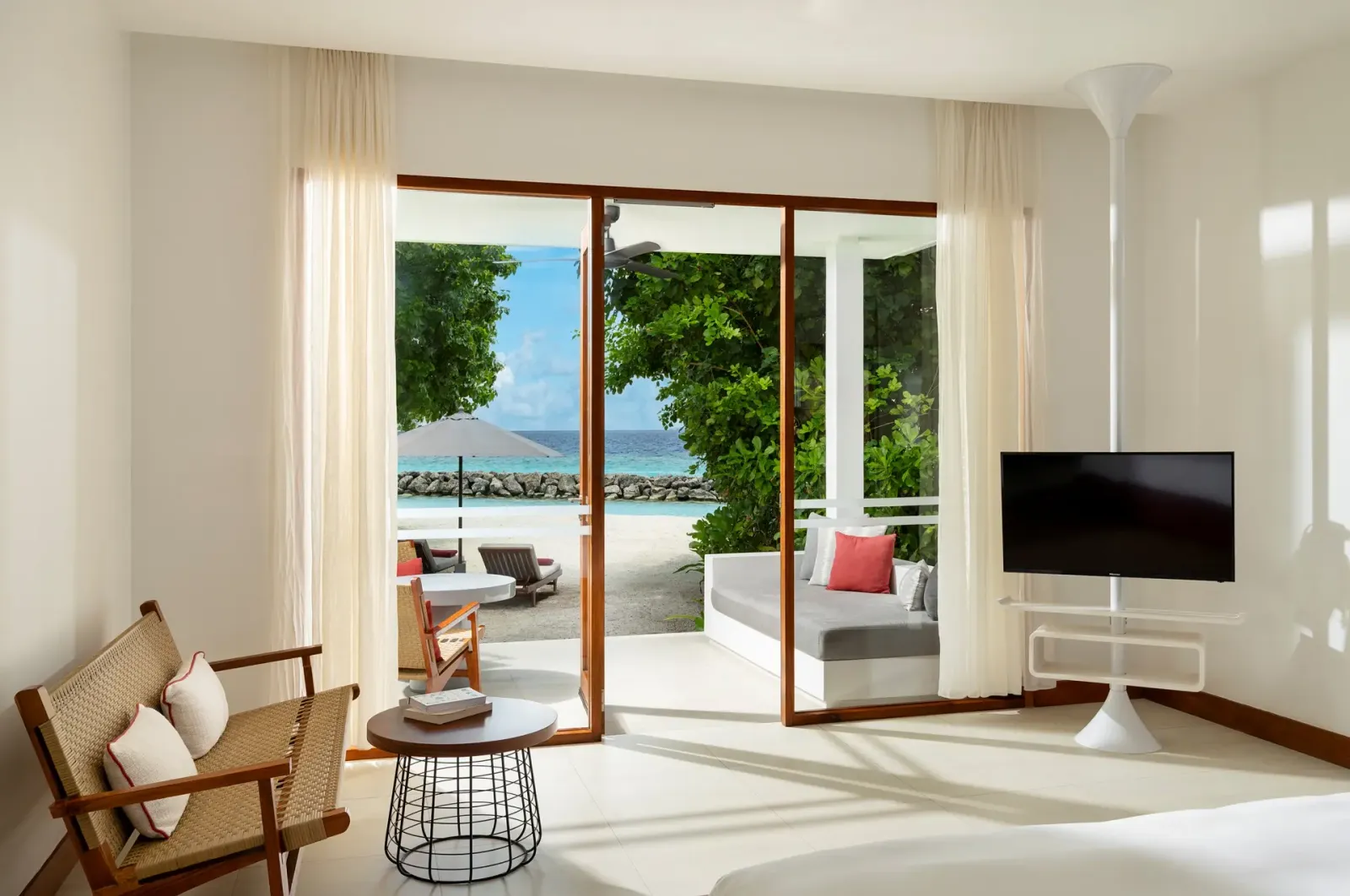 A Deluxe Beach Bungalow: the armchair, the window seat and the door open to the beach.