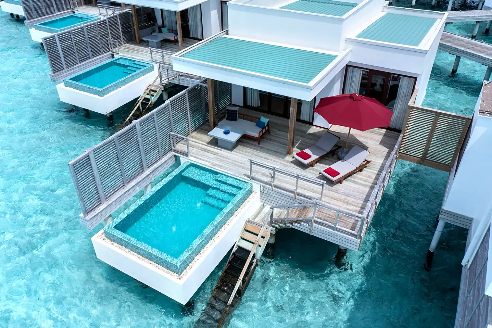 The Lagoon Villas with Pool from above: the pool at the edge of the deck and the steps into the lagoon.