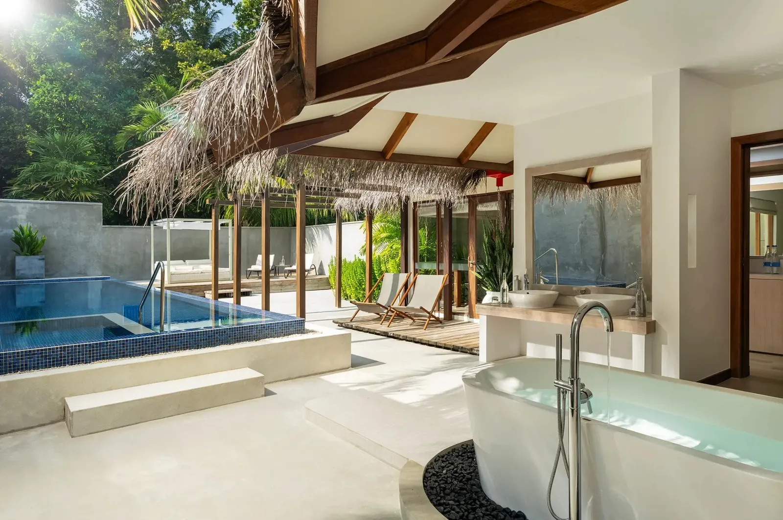 The Honeymoon Pool Villa’s open-air bathroom, the white tub and the pool in the garden