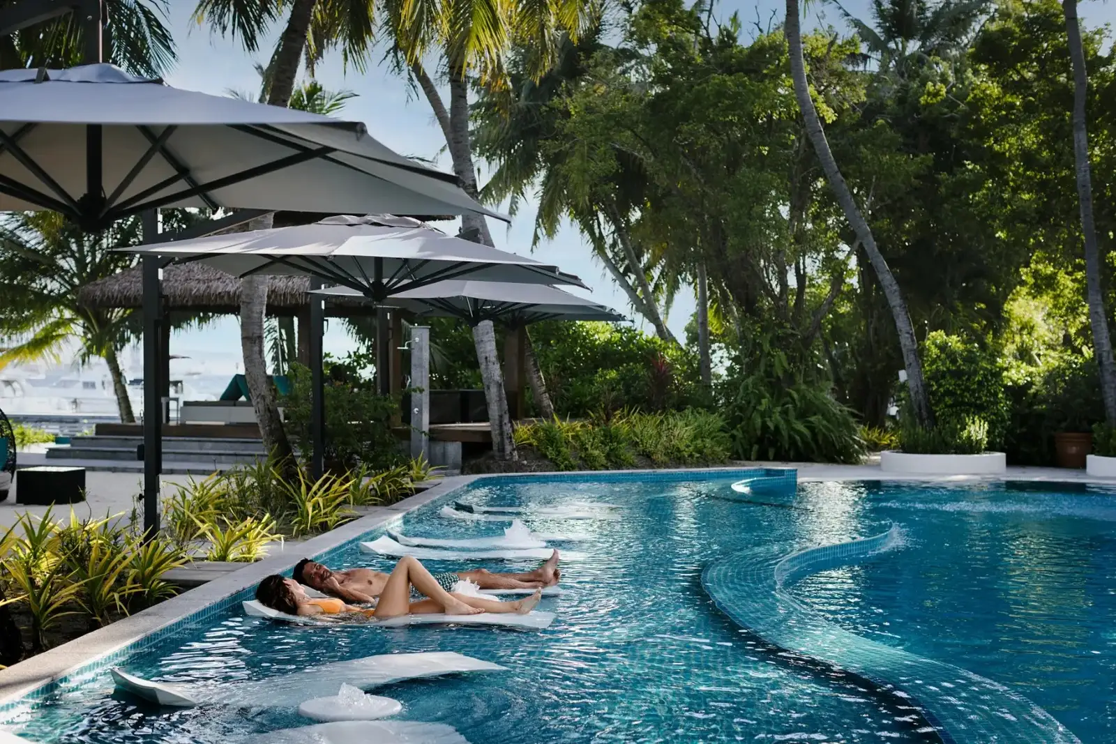 The pool among the umbrellas, guests in the water