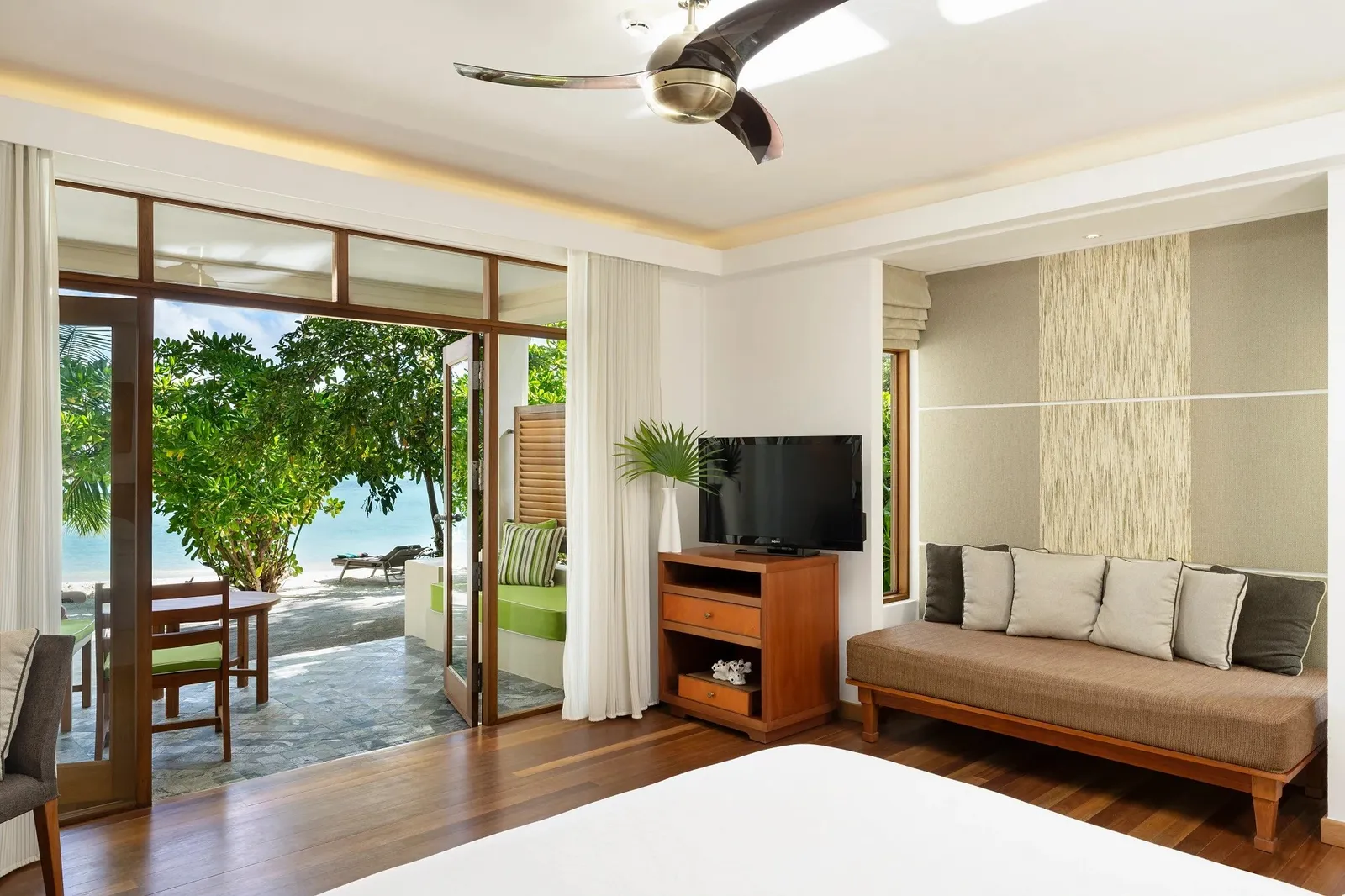A Deluxe Bungalow bedroom, the bed and the door to the garden