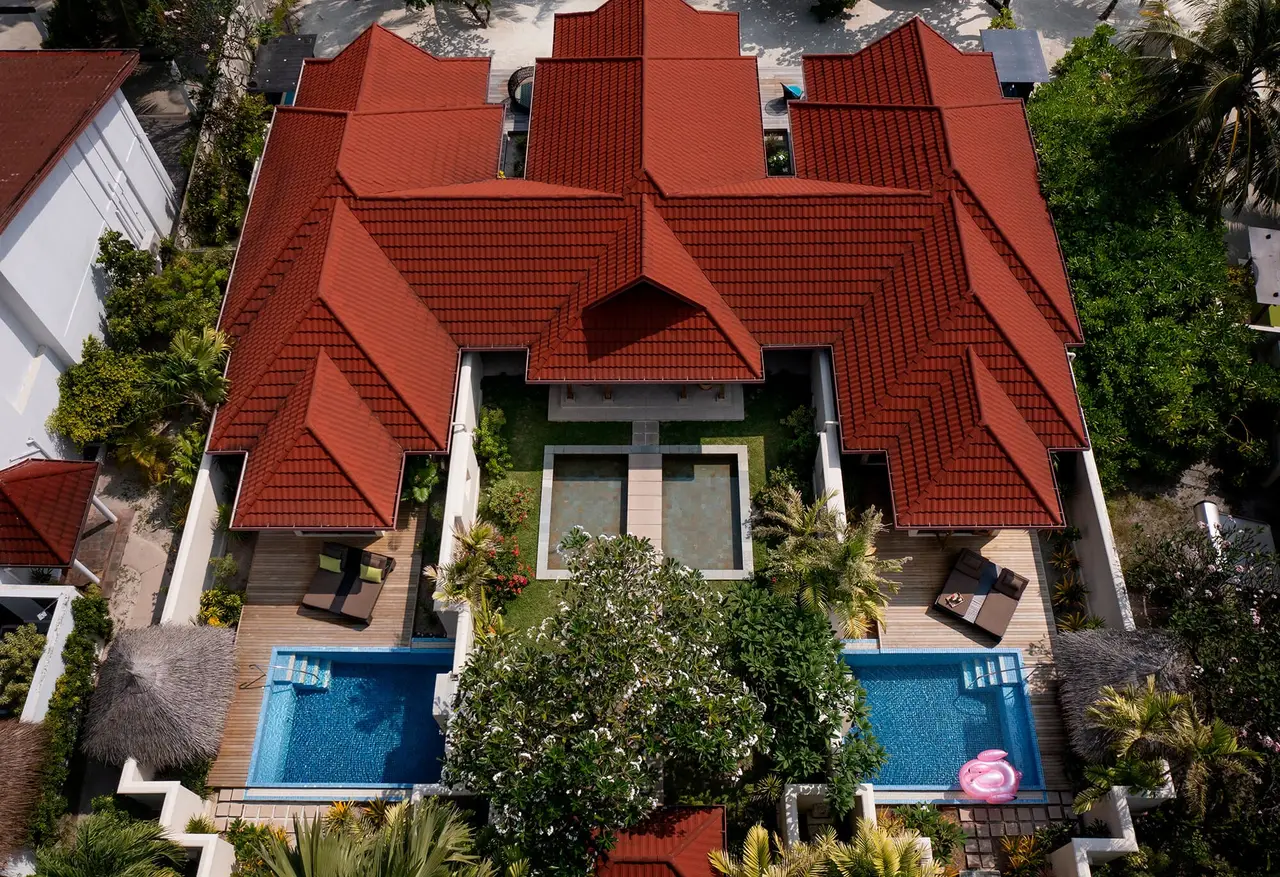 The Two Bedroom Kurumba Residence from the air, its red roofs and 2 pools