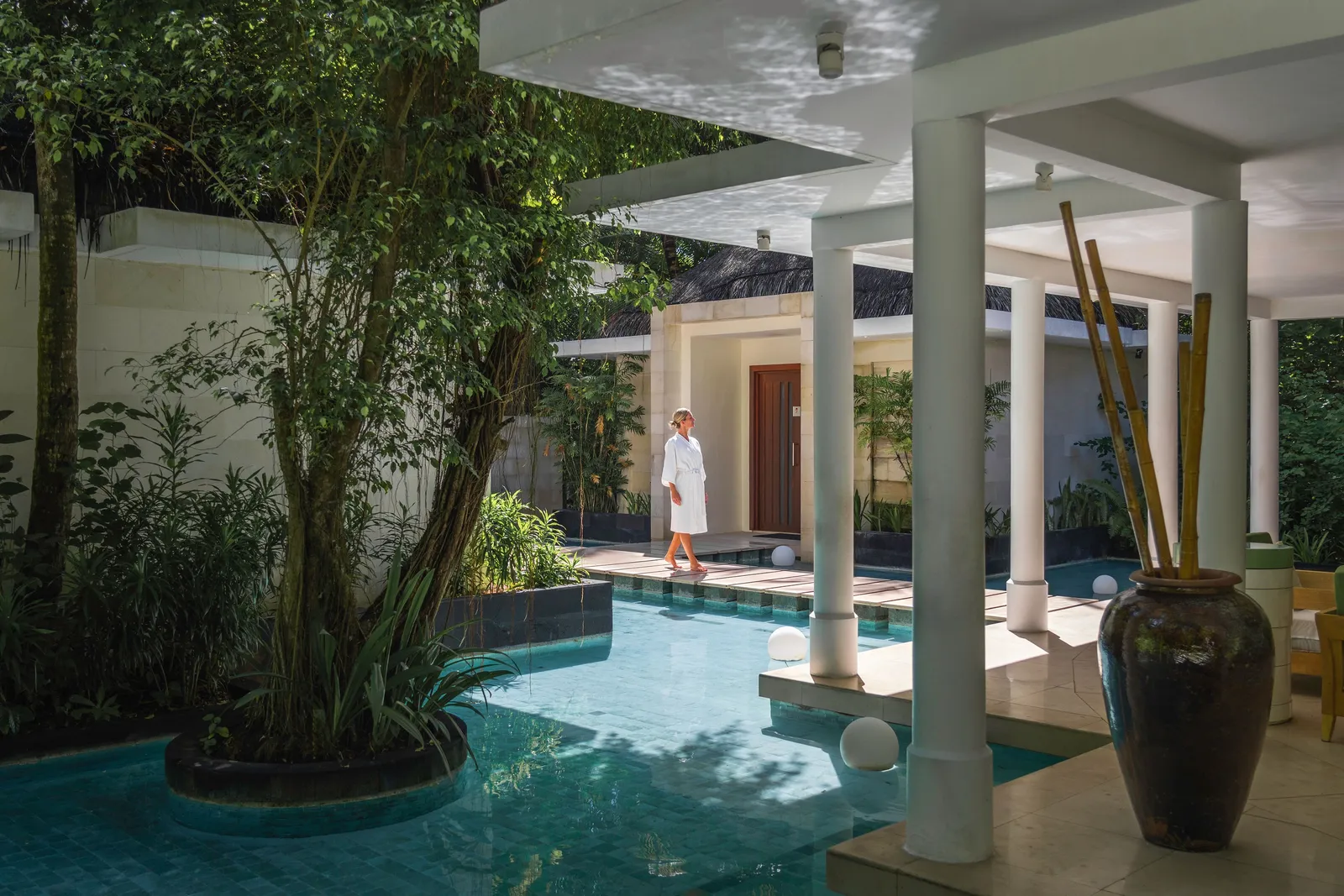 The Drift Spa courtyard, with its pool between white columns and greenery around