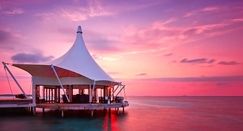 Edge at sunset, the restaurant over the water under its white canopy