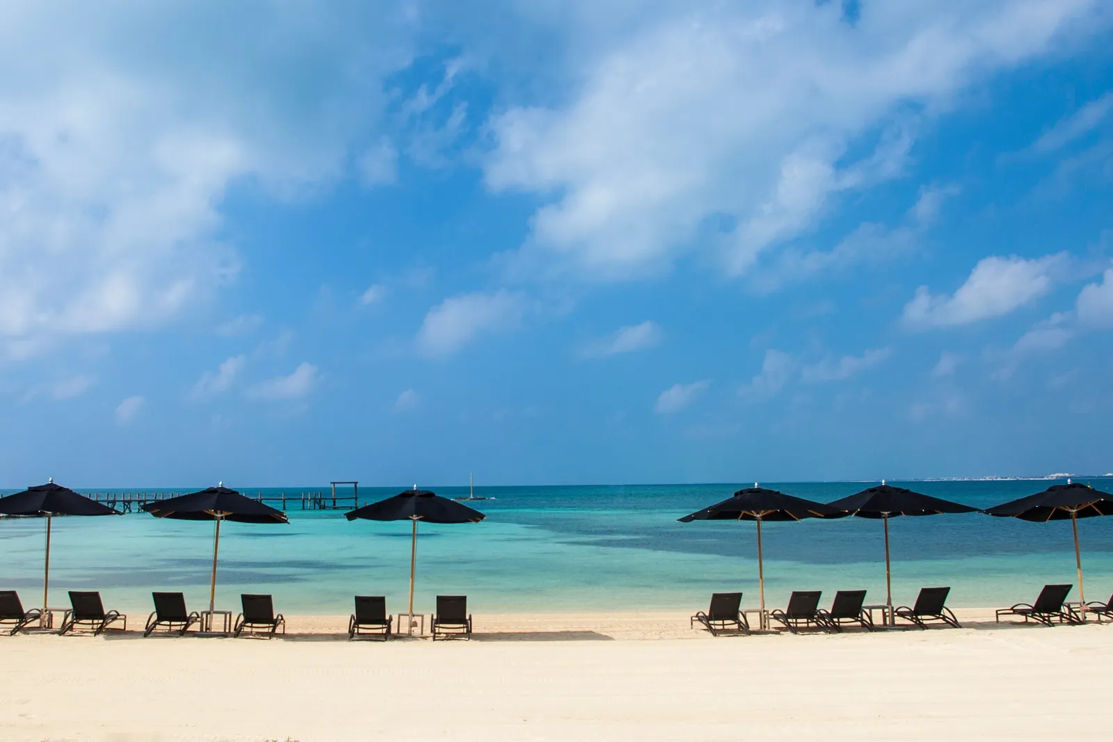 NIZUC beach with loungers, parasols and turquoise water