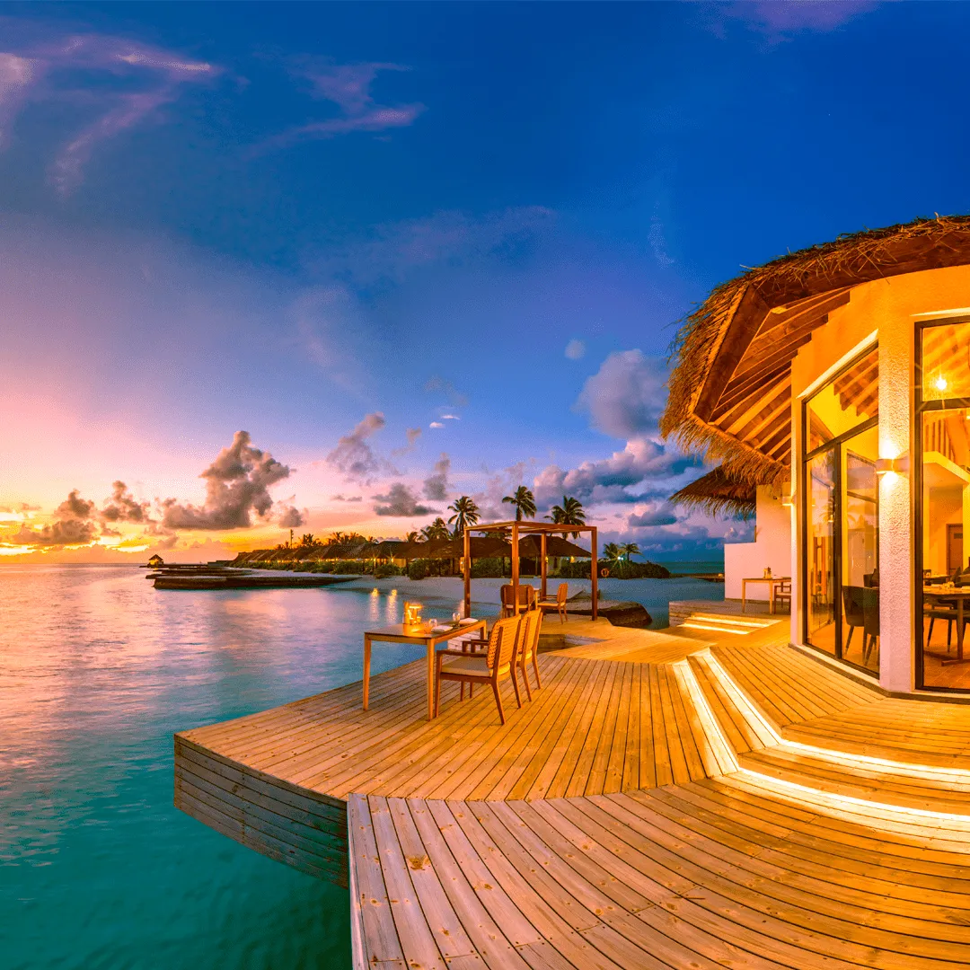 Laid tables on Flame’s timber deck at dusk