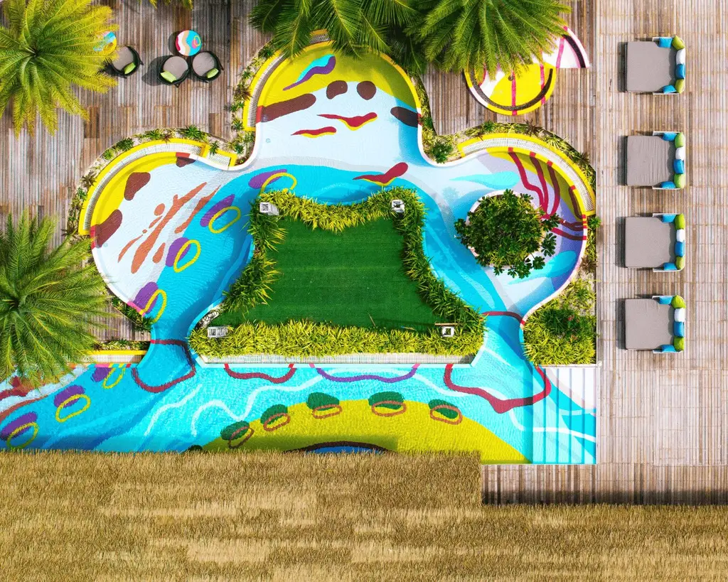 The Raa Baa pool from above, hand-painted in bright colours, with a lawn island in the middle and loungers along the edge.