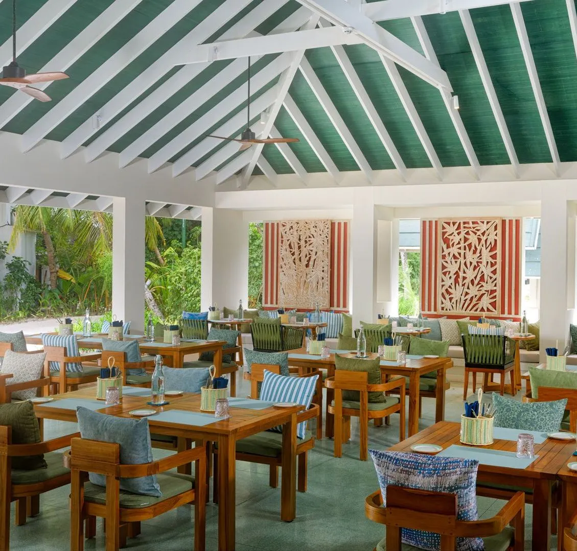 The Spice dining room, with its green-beamed ceiling, wooden tables and openings on to the garden