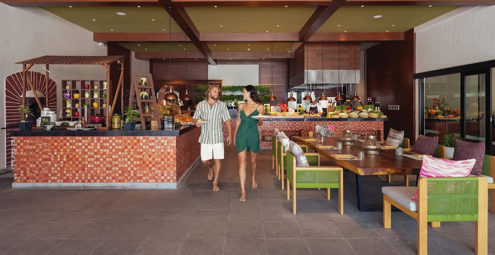 Ylang-Ylang’s dining room, with its open cooking stations and long tables under the wooden ceiling.