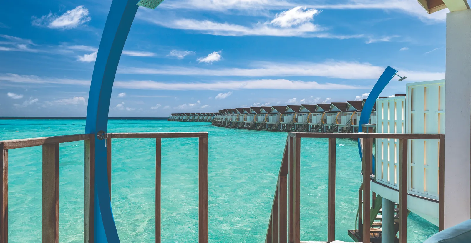 From a Water Villa’s deck, the steps and shower over the lagoon, with the row of other water villas beyond.