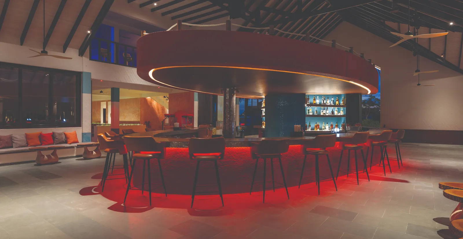 X360’s circular bar in the evening, its stools and a red glow under the counter.