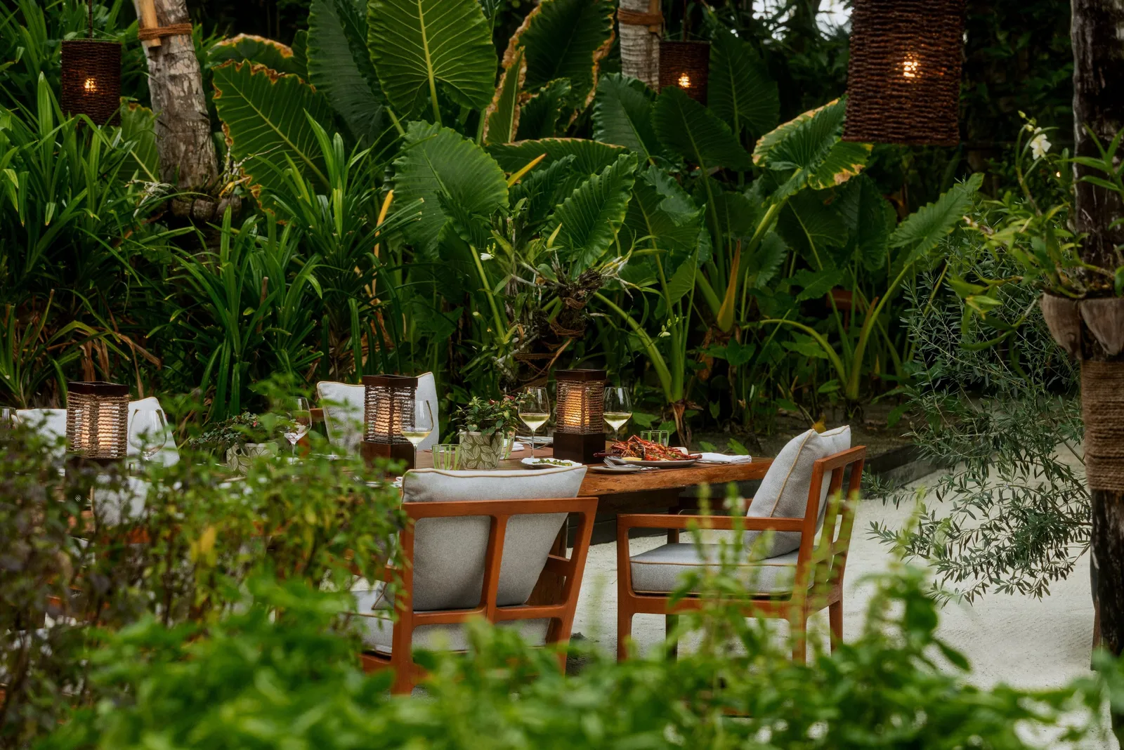 A table laid among the plants and lanterns of Botanica’s garden
