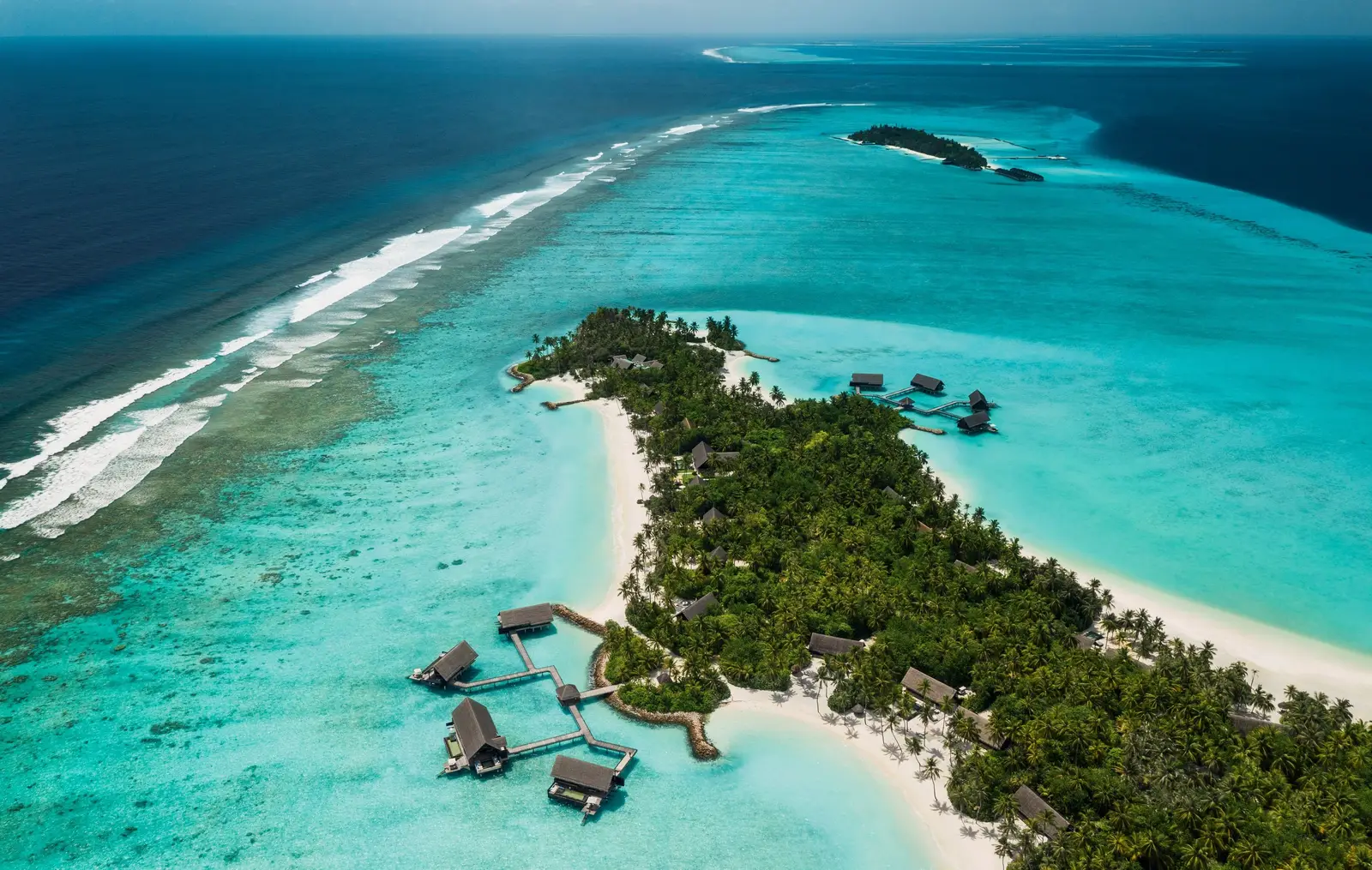 The whole island from the air, its water villas along the shore