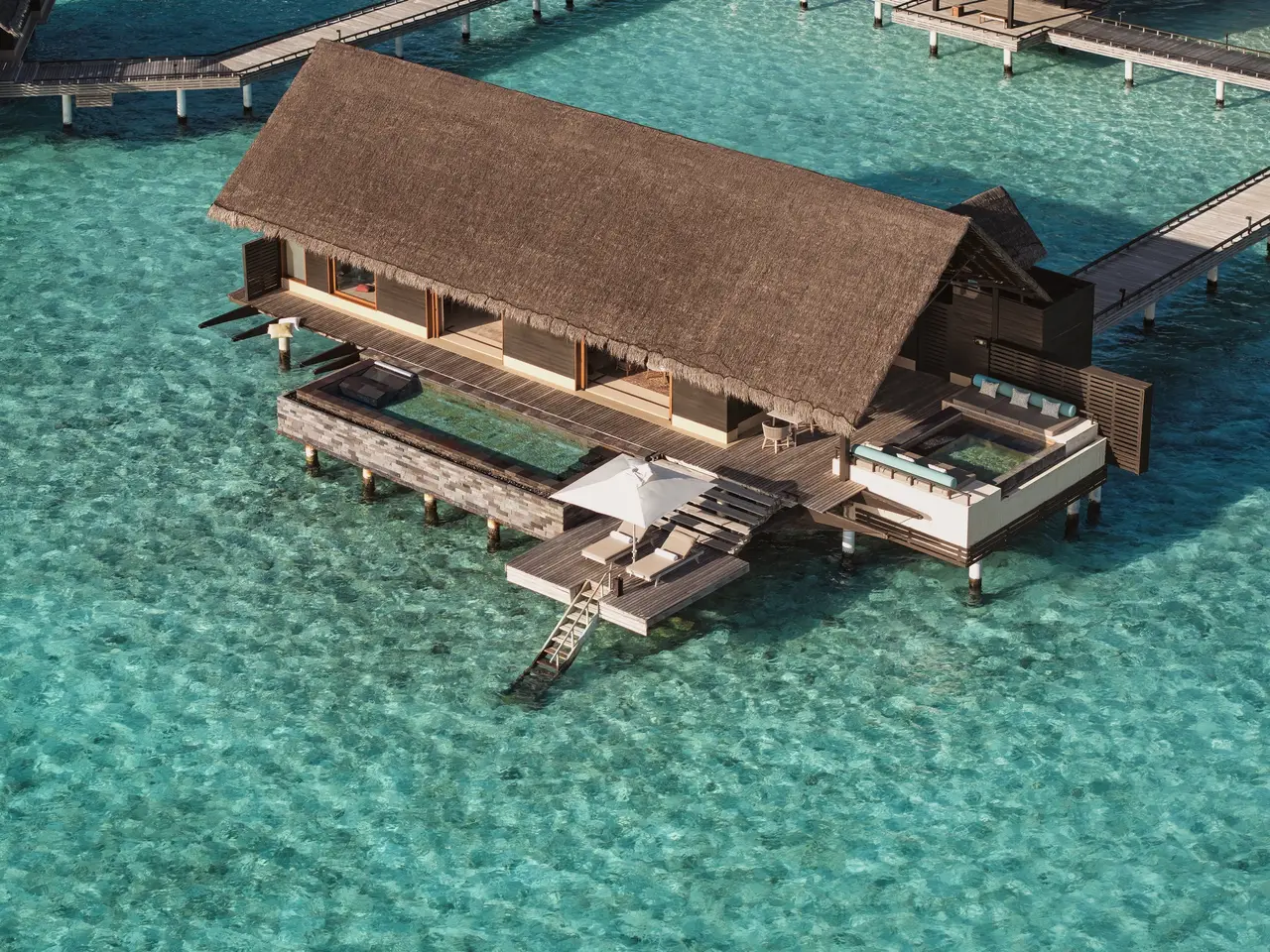 A Grand Water Villa With Pool from the air, with its long pool