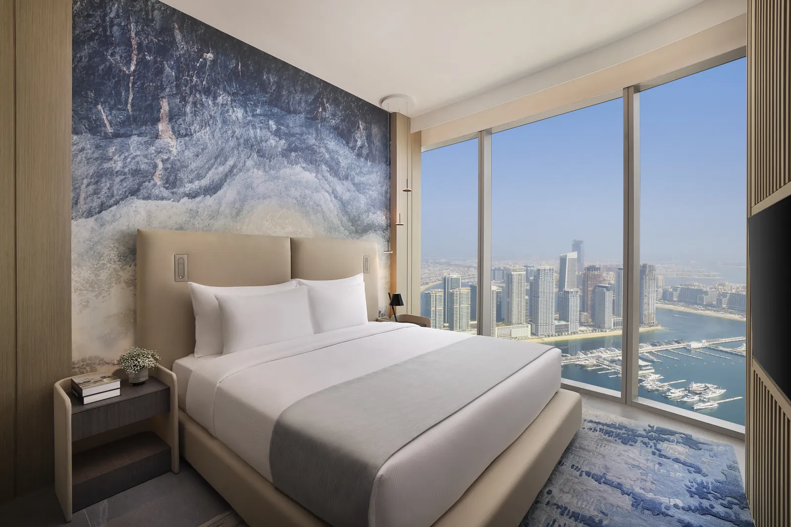 A Ciel Dubai Marina bedroom with floor-to-ceiling windows over the boats and towers