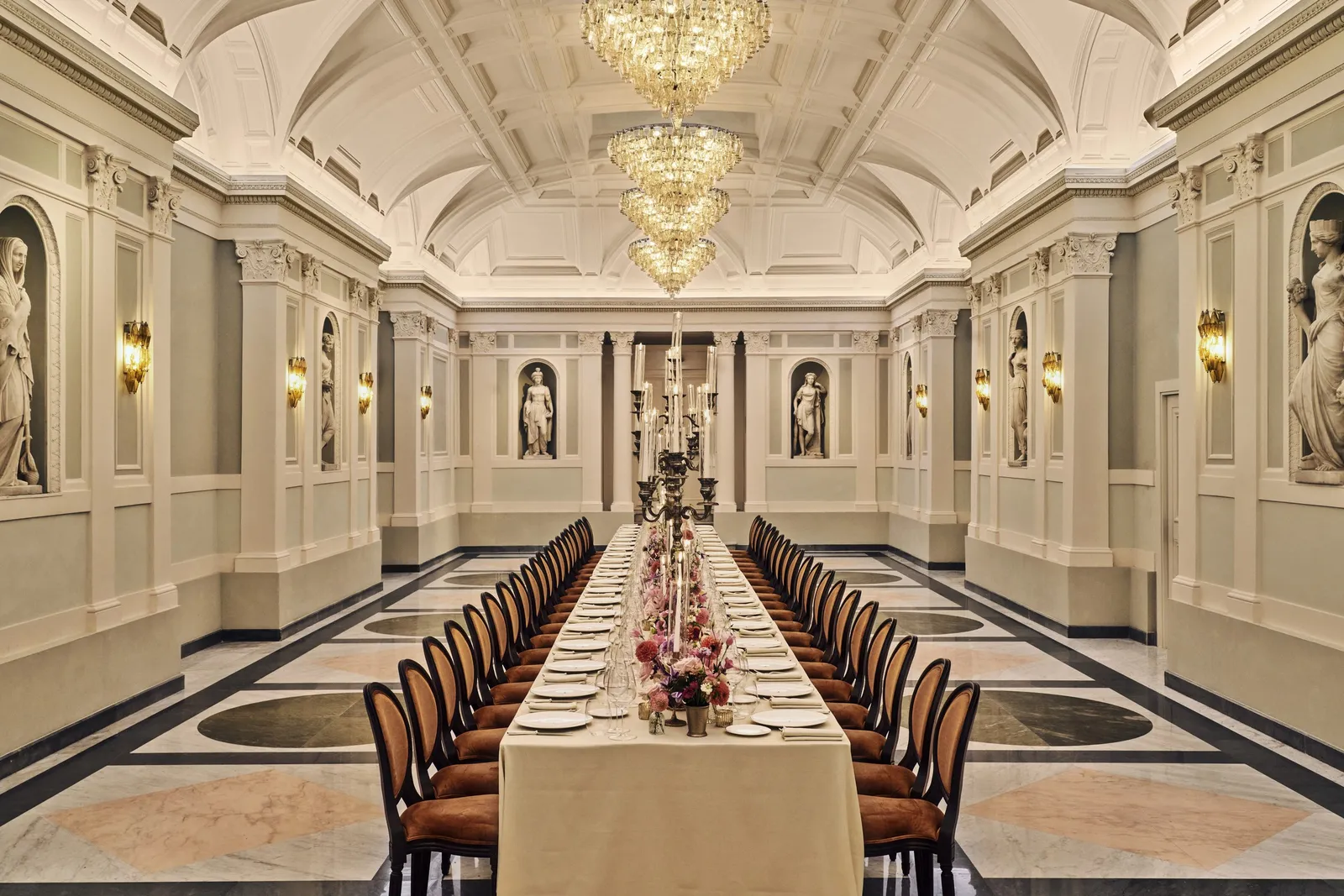 The Olimpo Ballroom laid for a banquet among Rinaldi’s statues