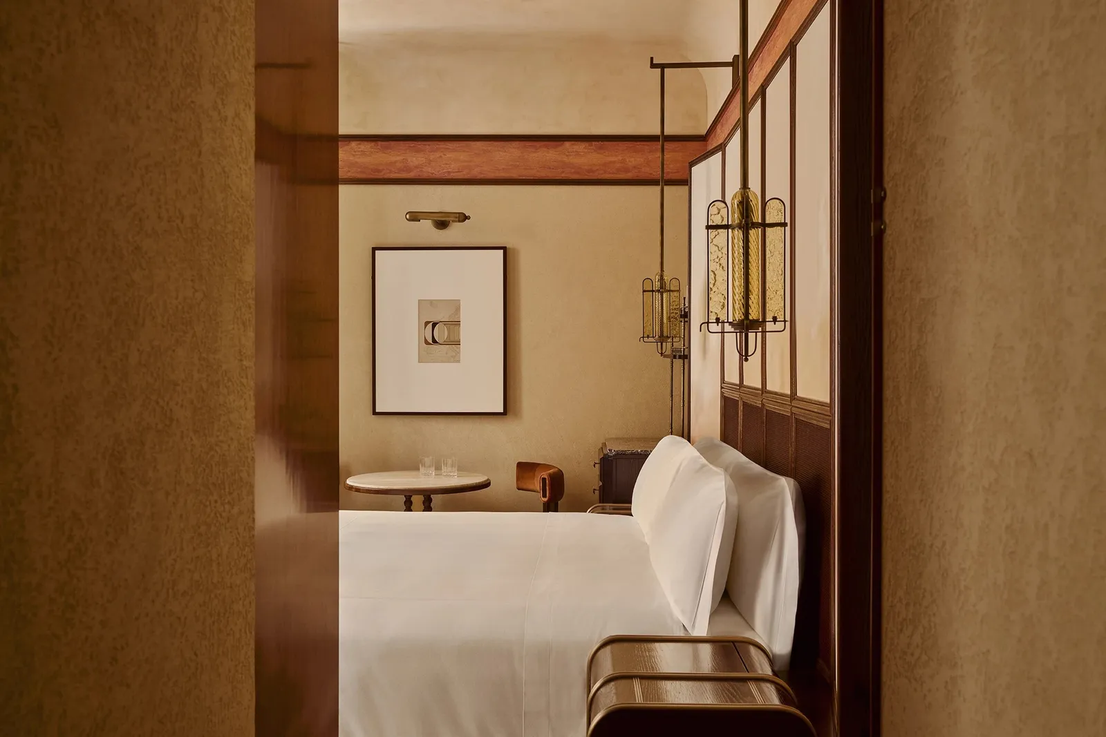 A Classic Room with a white bed, a wooden desk and a framed print