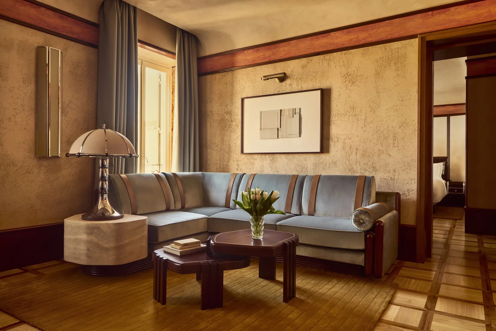 The Grand Suite with View’s living room with a sofa and a floor lamp