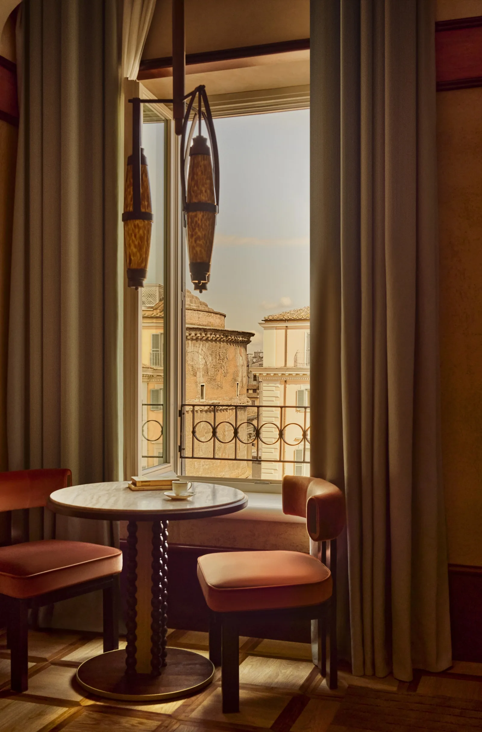 Junior Suite with View: a table for 2 at the open window over the rooftops