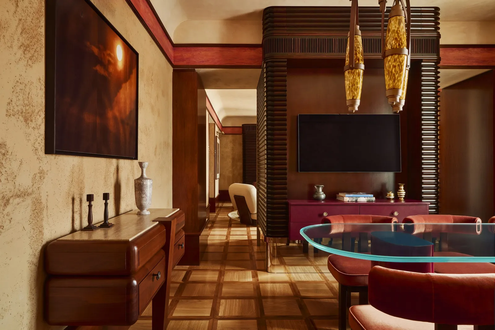 The Obelisco Suite’s dining room with a glass table and the windows