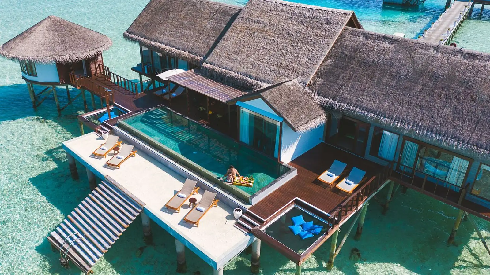 THE OZEN RESIDENCE from above, at the end of the jetty, with its pool, loungers and deck over the water.