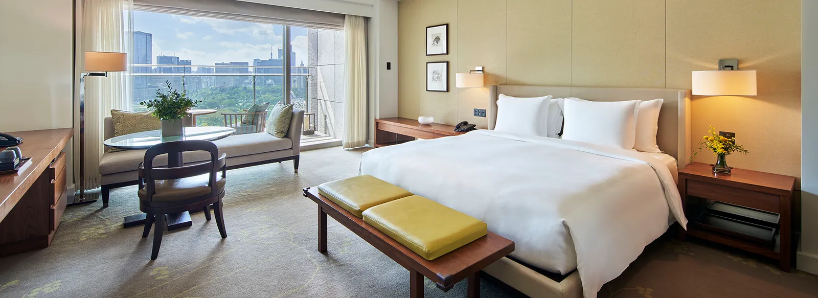 A Deluxe with Balcony: the king bed, the seating area and the window onto Wadakura park and the towers.