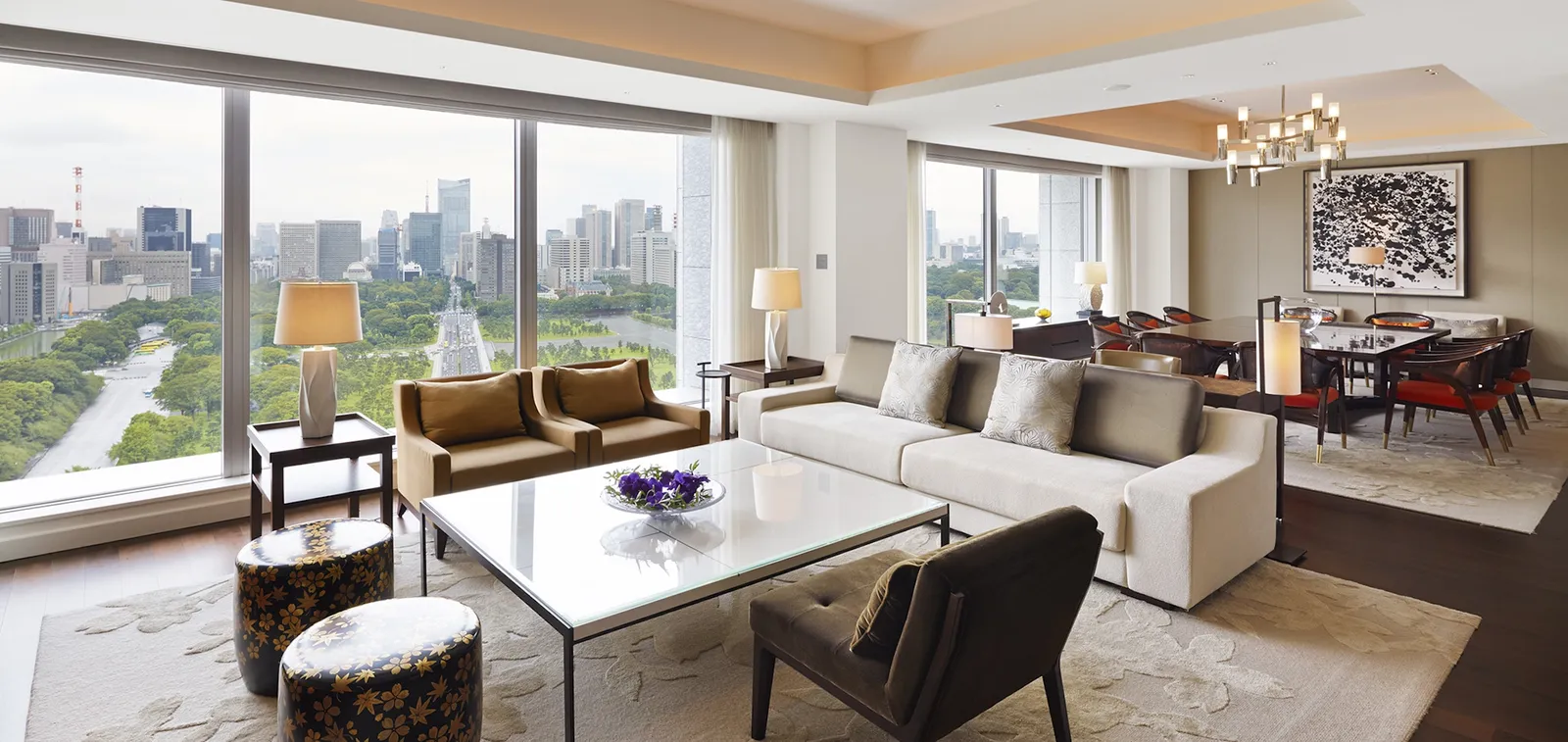 The Palace Suite’s large living room, with its sofas, dining table and windows onto the green.