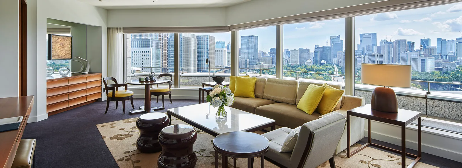 The Park Suite’s living room, its windows wrapping round the corner above the gardens and the skyline.