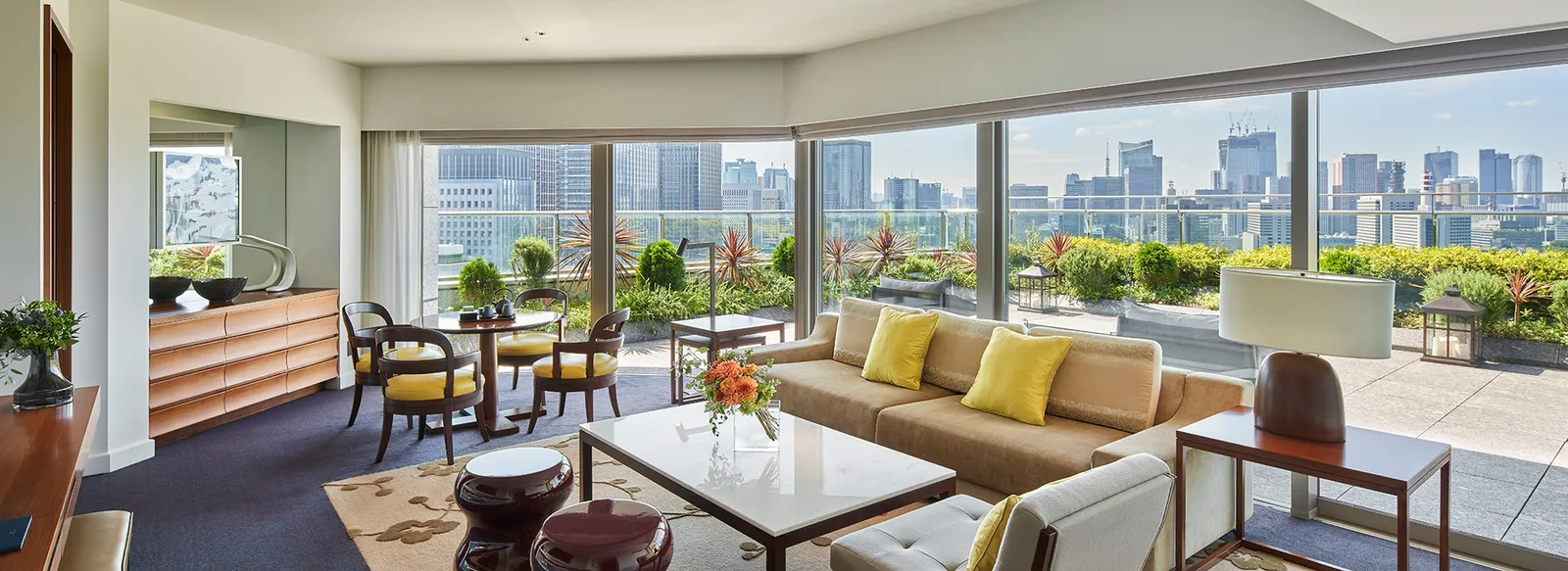 The Terrace Suite’s living room and, beyond the windows, the planted terrace and the Tokyo towers.