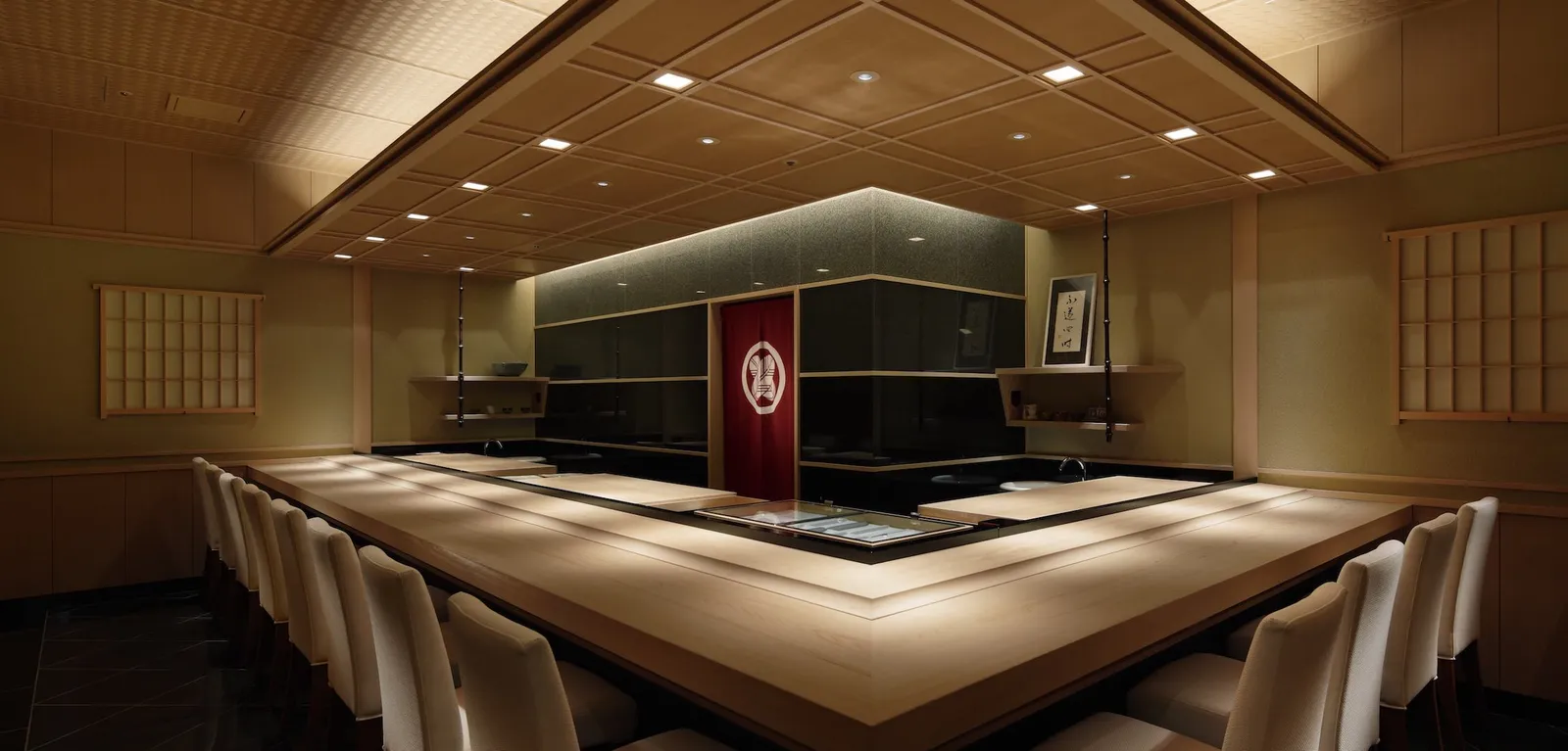 Sushi Kanesaka’s pale-wood counter, with its row of chairs and the noren curtain in front of the kitchen.
